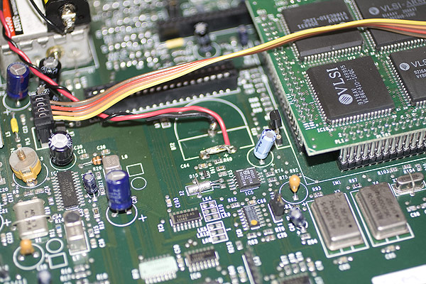 After cutting out the original battery, some power wires are connected to allow the battery to be mounted remotely